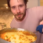 104858097-15397201-Brooklyn_Beckham_26_appeared_to_be_missing_British_cooking_as_he-a-37_17660889050.avif