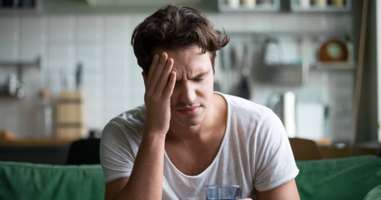 1767160393_0_Young-man-suffering-from-headache-migraine-or-hangover-at-home.jpg