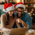 1_Couple-celebrating-christmas-at-home-using-laptop-for-online-shopping.jpg