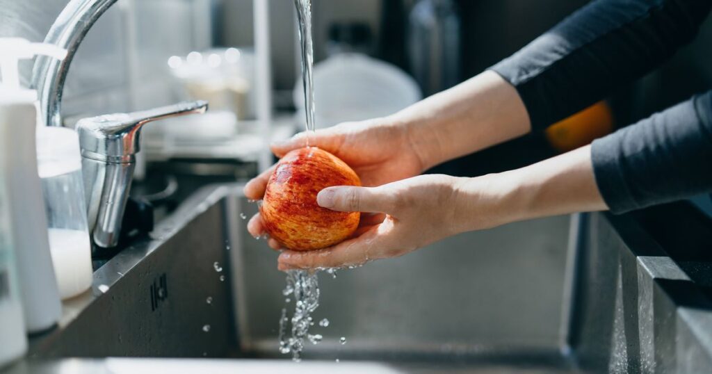 1_Cropped-shot-of-womans-hand-washing-an-red-apple-with-running-water-in-the-kitchen-sink-at-home.jp_.jpeg