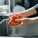 1_Cropped-shot-of-womans-hand-washing-an-red-apple-with-running-water-in-the-kitchen-sink-at-home.jp_.jpeg