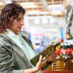 1_Woman-shopping-comparing-olive-oil-prices-in-supermarket.jpg