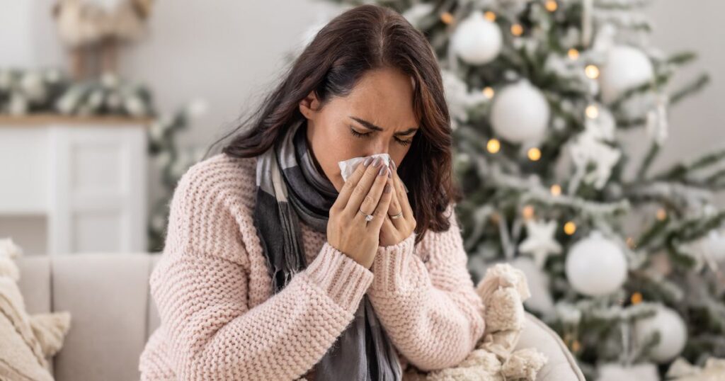 2_Woman-sneezes-as-she-lies-ill-with-cold-during-the-festive-Christmas-period.jpg