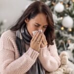 2_Woman-sneezes-as-she-lies-ill-with-cold-during-the-festive-Christmas-period.jpg