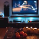 3_Dark-indoor-scene-with-candles-clementines-and-fairy-lights-in-front-of-a-TV-Germany.jpg