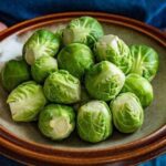 3_Woman-holding-bowl-with-raw-brussels-sprouts.jpg