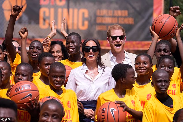 84786731-15401775-Prince_Harry_and_Meghan_at_the_Dream_Big_Basketball_Clinic_in_La-a-1_1766236109313.avif