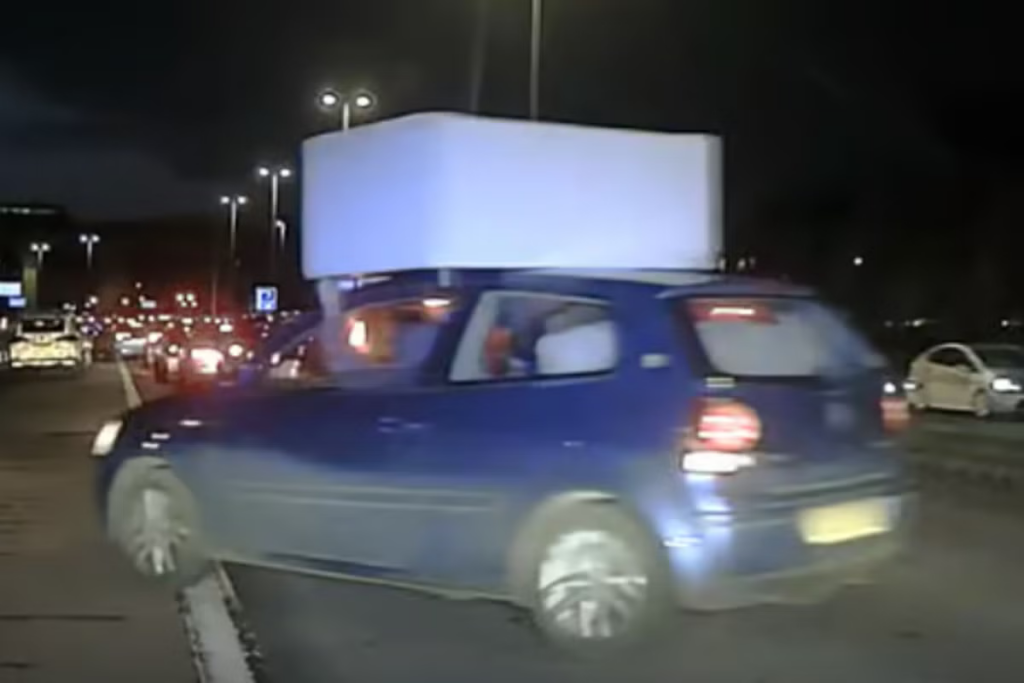 Police-stop-driver-balancing-sofa-on-car-roof.png