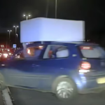 Police-stop-driver-balancing-sofa-on-car-roof.png