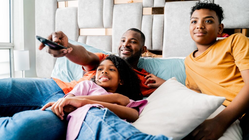 family-watching-tv-bedroom-home-1046018958_26a1d2.jpg