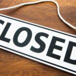 shop-closed-sign-wooden-surface-1047711324.jpg
