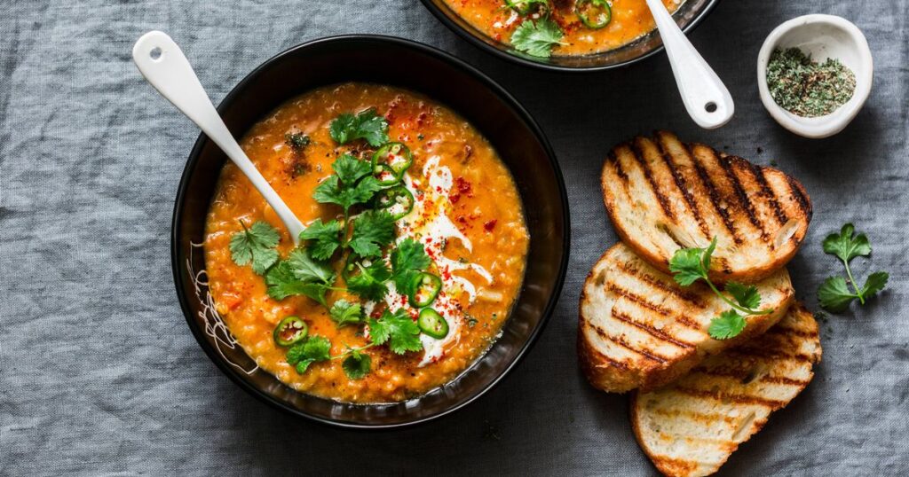 0_Curried-red-lentil-tomato-and-coconut-soup-delicious-vegetarian-food-on-grey-background-top-view-F.jpeg