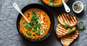 0_Curried-red-lentil-tomato-and-coconut-soup-delicious-vegetarian-food-on-grey-background-top-view-F.jpeg