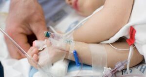 0_Father-holding-hand-of-toddler-in-hospital-hooked-up-to-IV-pulse-ox.jpg