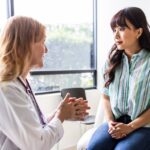 0_Female-doctor-talking-with-young-woman-in-exam-room.jpg