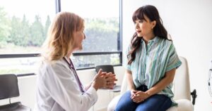 0_Female-doctor-talking-with-young-woman-in-exam-room.jpg