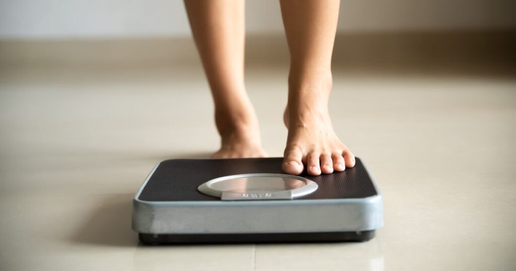 0_Female-leg-stepping-on-weigh-scales-Healthy-lifestyle-food-and-sport-concept.jpg