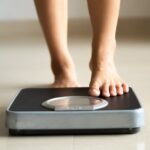 0_Female-leg-stepping-on-weigh-scales-Healthy-lifestyle-food-and-sport-concept.jpg