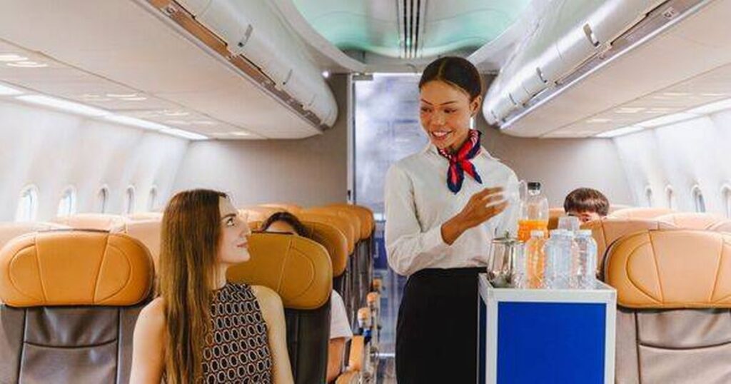 0_Flight-attendant-offering-inflight-refreshments-to-a-seated-passenger-with-a-smile-Represents-qual.jpeg