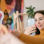 0_Front-view-of-a-young-woman-taking-a-photo-with-her-smartphone-to-a-shirt.jpg
