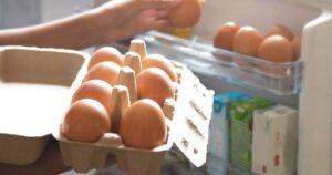 0_Hand-Pick-chicken-egg-from-egg-carton-box-into-refrigerator-eggs-on-shelf-of-cold-storage.jpg