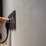 0_Hand-plugging-electrical-cord-into-wall-socket.jpg