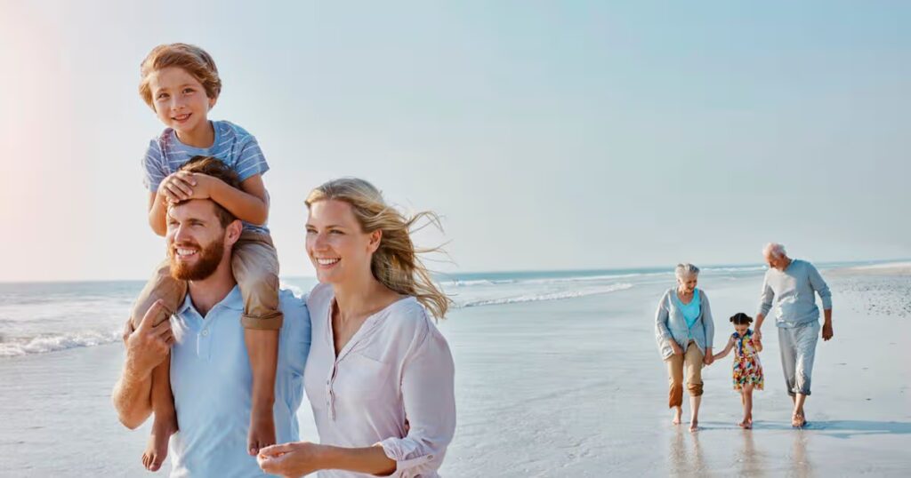 0_Happy-extended-family-strolling-on-the-beach.jpg
