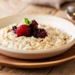 0_High-angle-close-up-of-bowl-of-porridge-with-mixed-berry-compote-in-a-cafe.jpg