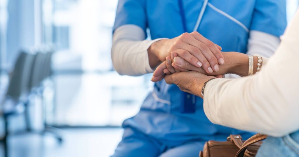0_Nurse-consoling-a-patient-and-holding-her-hands-at-the-hospital.jpg