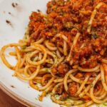 0_Spaghetti-bolognese-pasta-with-minced-meat-and-vegetables-Horizontal-side-view-on-wooden-backgroun.jpeg