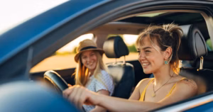 0_Two-best-friends-enjoy-a-car-trip-on-their-summer-vacation-They-smile-create-shared-memories-and-e.avif