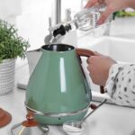 0_Woman-pouring-vinegar-from-bottle-into-electric-kettle-in-kitchen-closeup.jpg