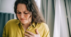 0_Woman-suffering-from-chest-pain-holding-hand-over-heart.jpg