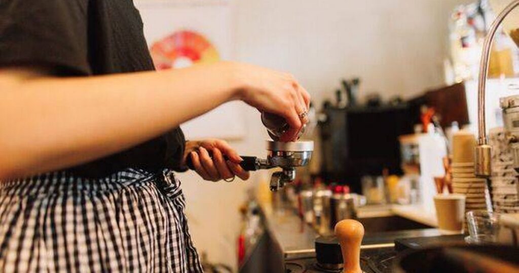 0_Woman-tamping-an-espresso-shot-to-put-into-machine.jpg