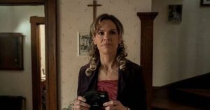 0_a-woman-stands-in-the-hallway-of-a-religious-home-and-holds-a-camera.jpg