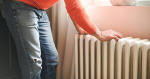 0_mature-adult-man-sits-and-warms-himself-by-the-radiator-in-the-room.jpg