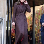 105347829-15446639-Kate_wore_a_full_length_burgundy_tartan_double_breasted_coat_by_-a-1_176797858085.avif