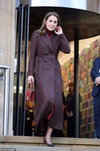 105347829-15446639-Kate_wore_a_full_length_burgundy_tartan_double_breasted_coat_by_-a-1_176797858085.avif