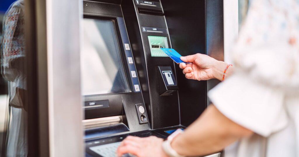 1767422057_0_Woman-using-ATM-for-cash-withdrawal-with-credit-card.jpg
