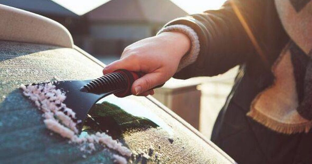 1_A-woman-scrapes-frost-off-the-front-window-of-her-car-on-a-cold-winter-morning.jpg