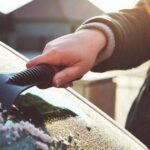 1_A-woman-scrapes-frost-off-the-front-window-of-her-car-on-a-cold-winter-morning.jpg