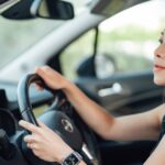 1_Side-view-of-young-Asian-woman-driving-a-car.jpg