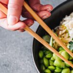1_Woman-eating-poke-salad-with-chopsticks.jpg