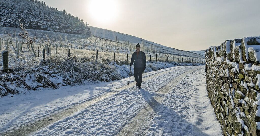2_A-person-walks-through-the-snow-at-Blackmoss-Reservoir-in-Barley.jpg
