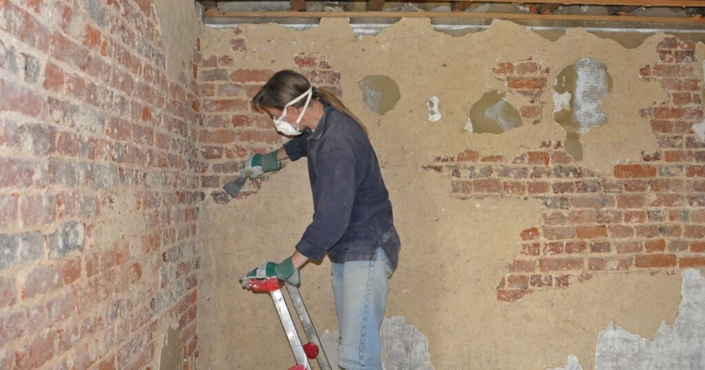 2_DIY-woman-cleaning-the-brick-wall-of-a-room.jpg