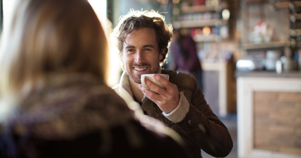 2_Man-having-coffee-while-looking-at-woman-in-cafe.jpg