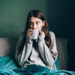 2_Sick-leave-and-seasonal-indisposition-at-home-Young-woman-drink-hot-tea-wrapped-in-blanket-in-cold.jpeg