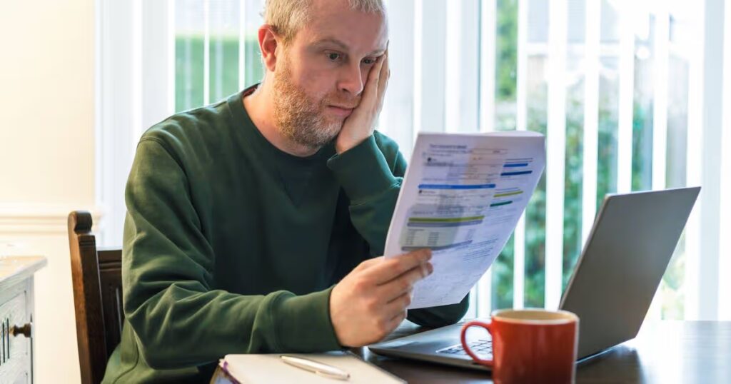 2_Worried-man-checking-bills-at-home.jpg