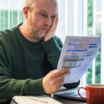 2_Worried-man-checking-bills-at-home.jpg