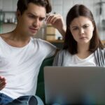 4_Millennial-couple-annoyed-by-stuck-laptop-confused-by-online-news.jpg